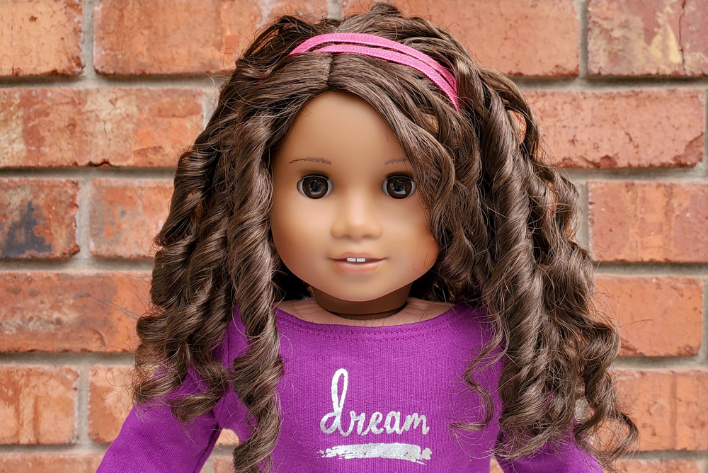 Gabriela McBride American Girl doll has curly brown hair, warm brown eyes and light brown skin