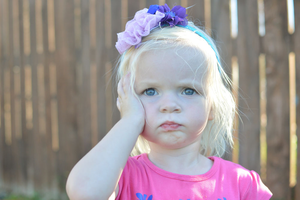 Toddler girl wearing a flower headband - Mommy Scene