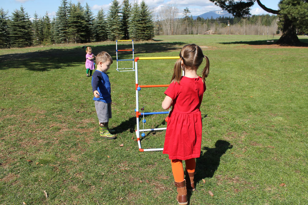 Primary Kids Clothing and playing ladder ball in the backyard - Mommy Scene