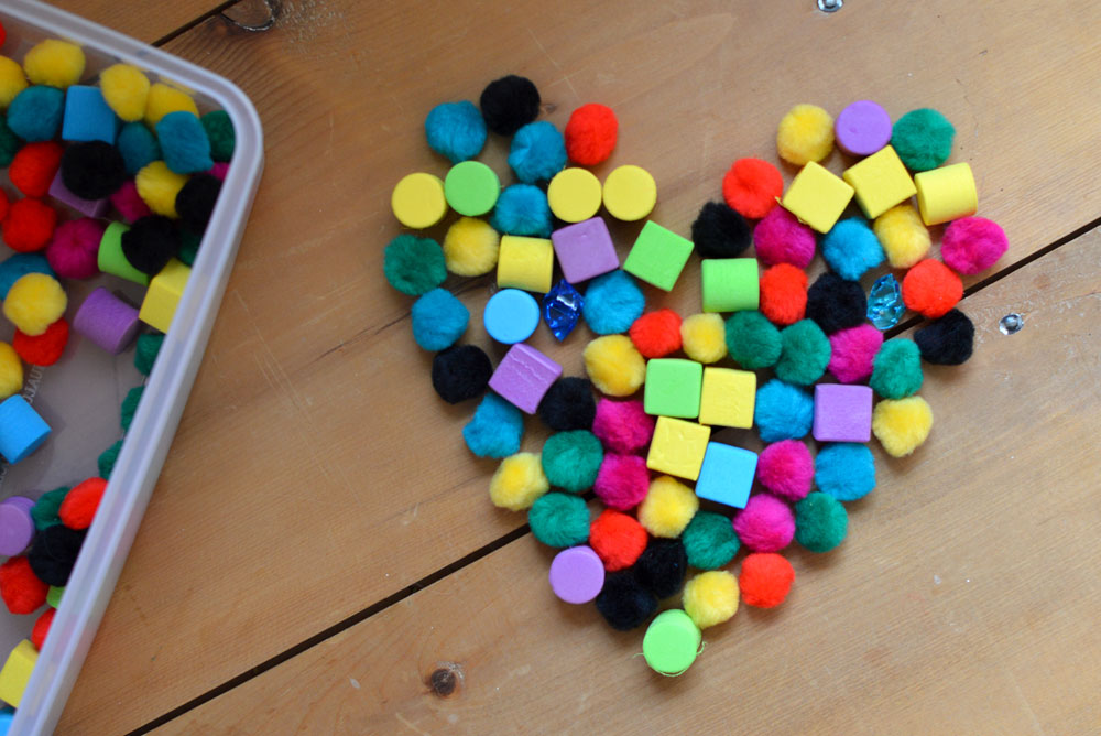 Playing with Pom Poms creating shapes preschool activity - Mommy Scene