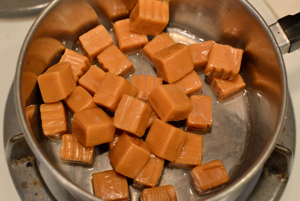Melt caramel candies to make DIY caramel apples