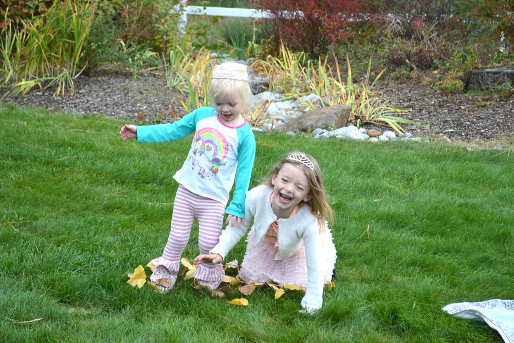 Sisters jumping in the leaves