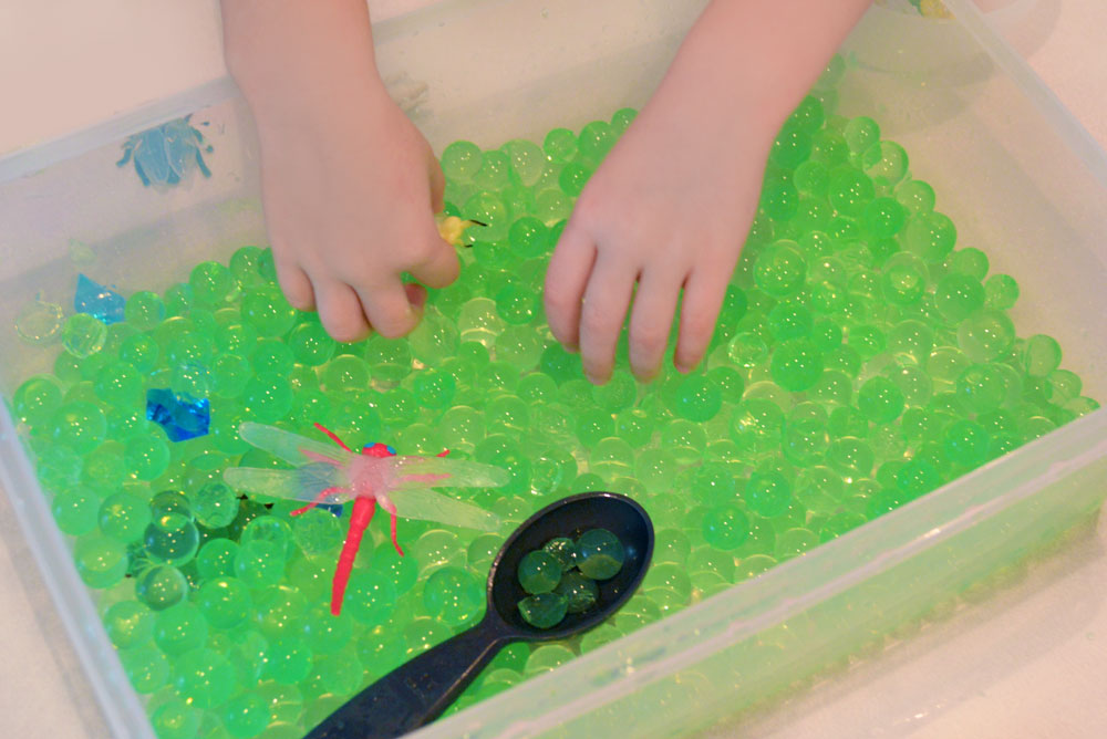 Kids sensory bin with water beads and bugs