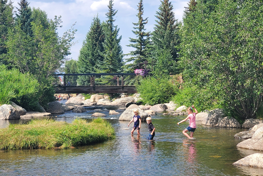Kids playing Blue River Riverwalk in Breckenridge Colorado