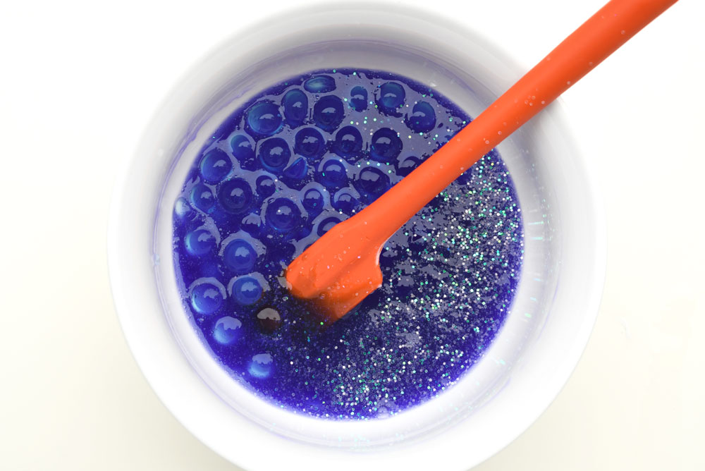 Mix water beads into homemade sensory slime