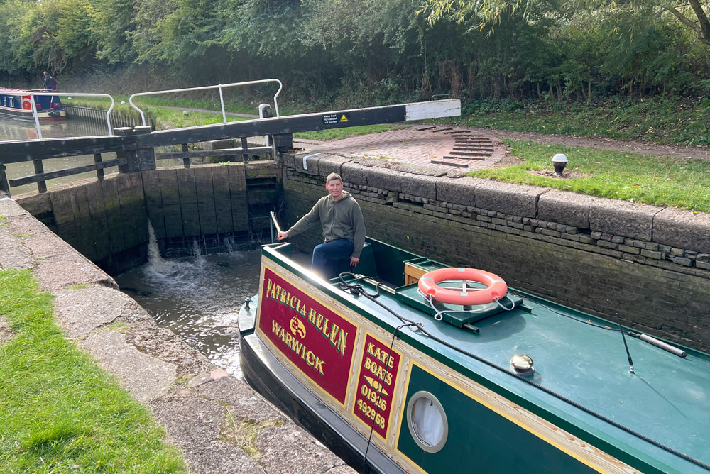 Navigating a narrowboat through a canal lock in England