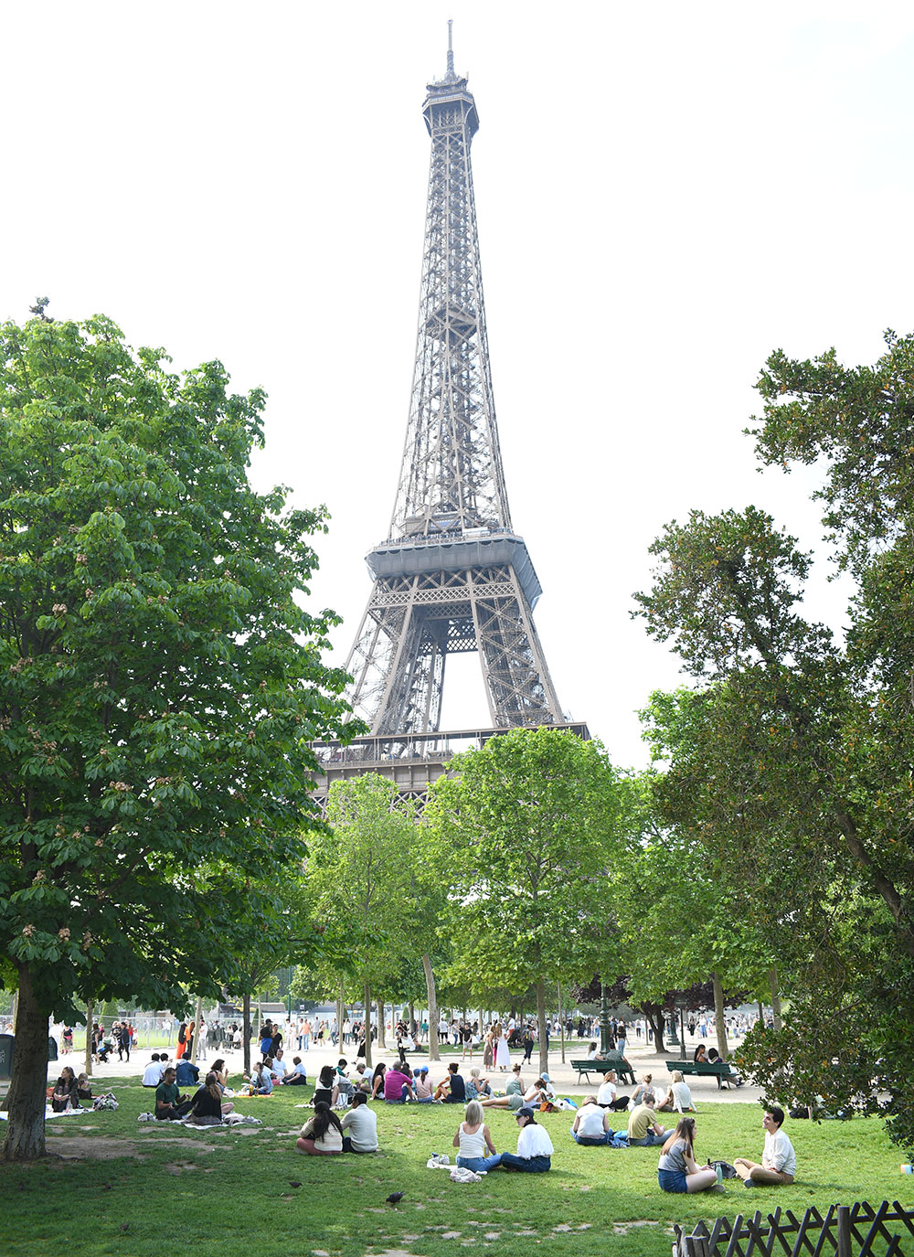 people relaxing near Eiffel Tower in Paris