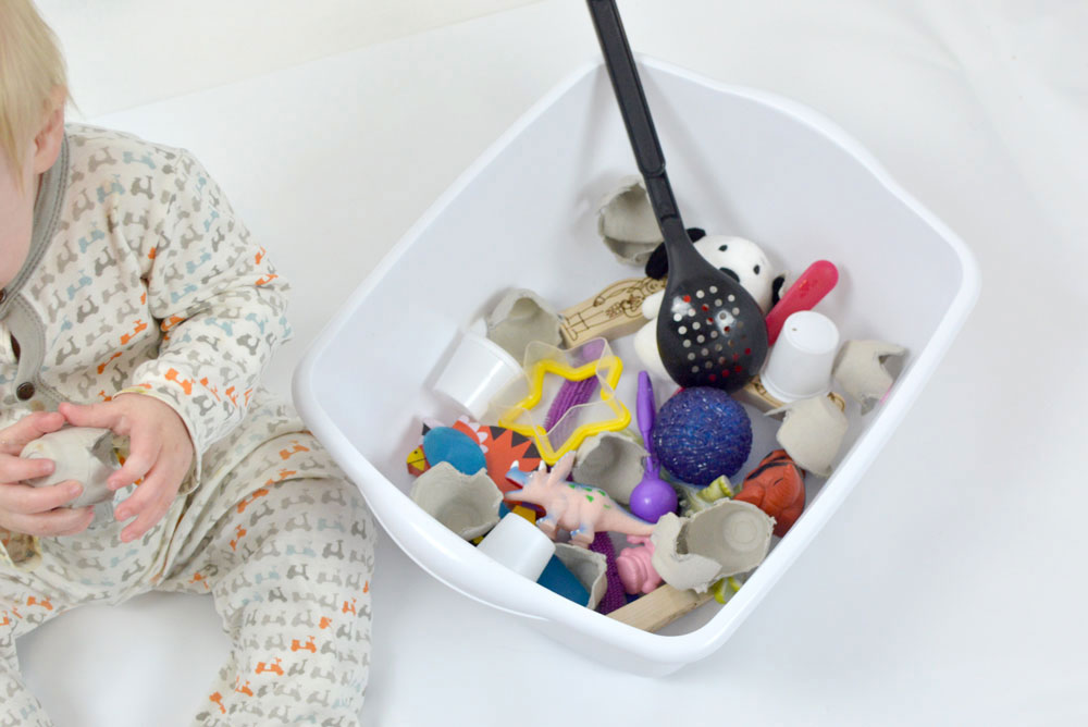 sensory bin for babies with large toys and textures