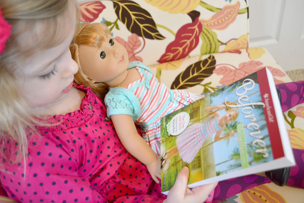 girl reading with American Girl doll