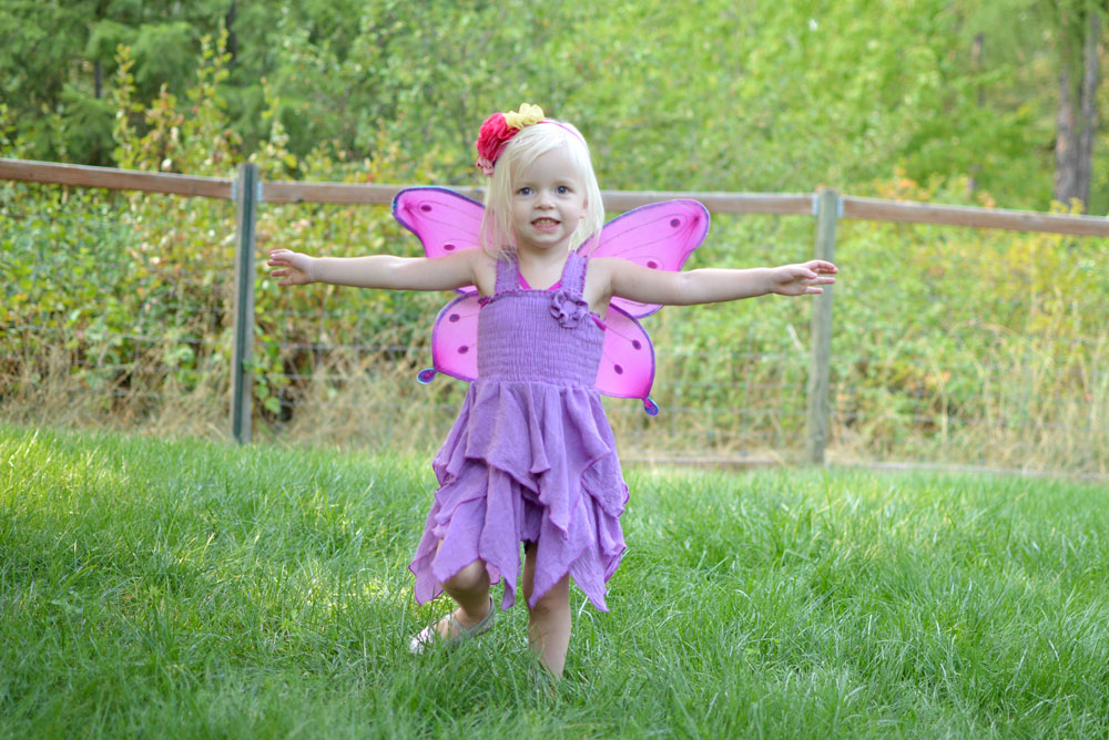 toddler girl wearing purple fairy dress