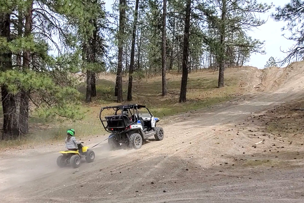 towing kids 50cc ATV at the off-road vehicle park