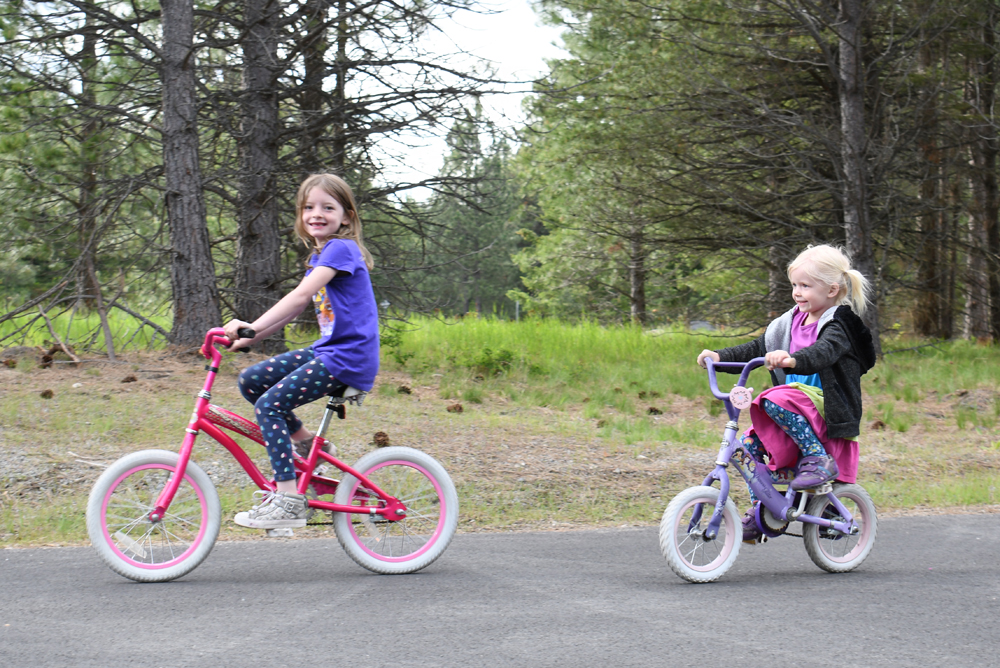 Kids riding bikes while camping at Farragut State Park near Coeur d’Alene Idaho