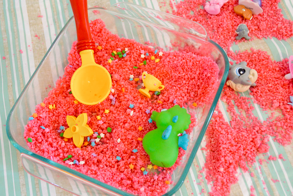 playing with homemade sensory sand made with cornstarch