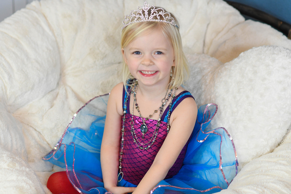 little girl with layered necklaces